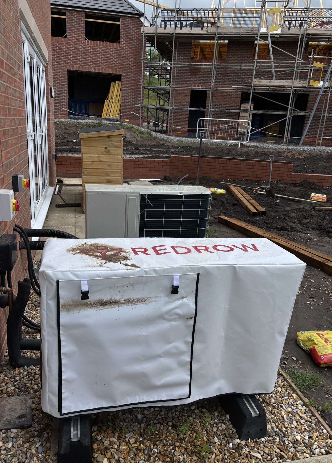 Redrow branded heat pump cover fitted on a live development