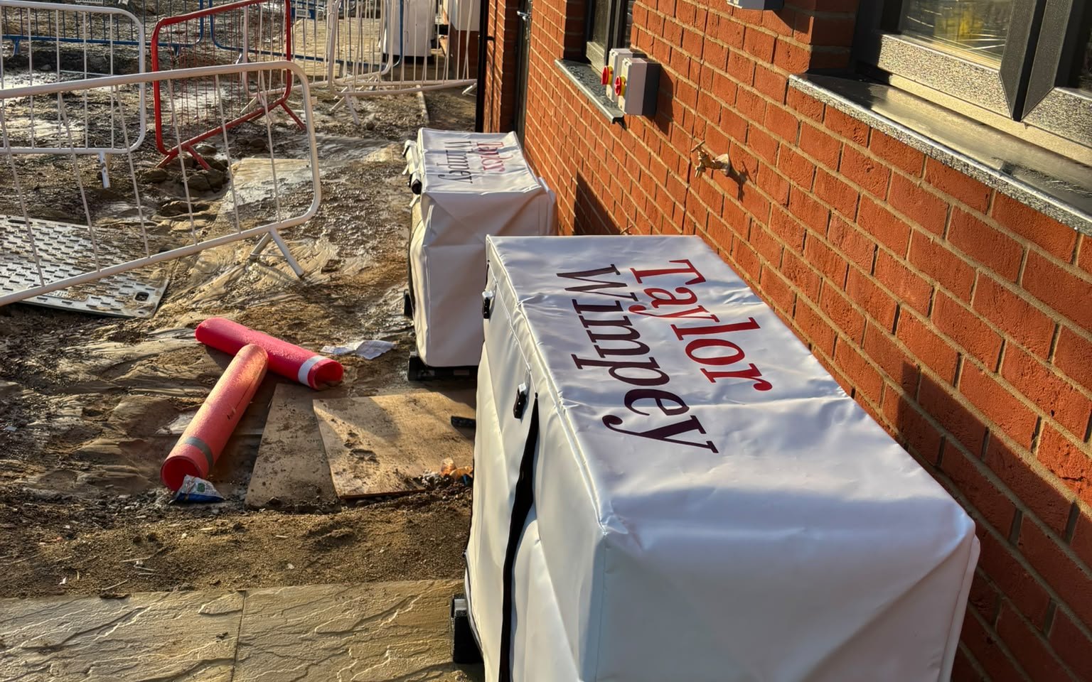 Taylor Wimpey branded heat pump covers fitted on site